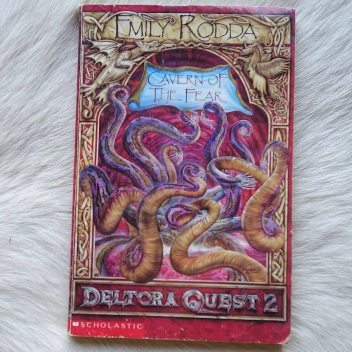 Book titled 'Cavern of the Fear' by Emily Rodda on a textured surface